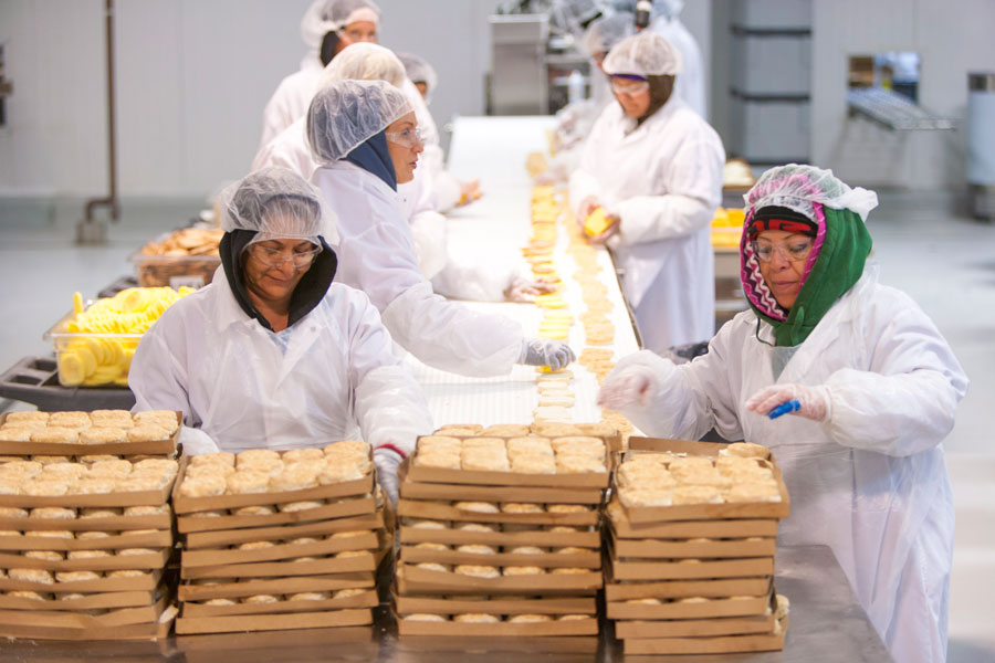 women associates with boxes of biscuits
