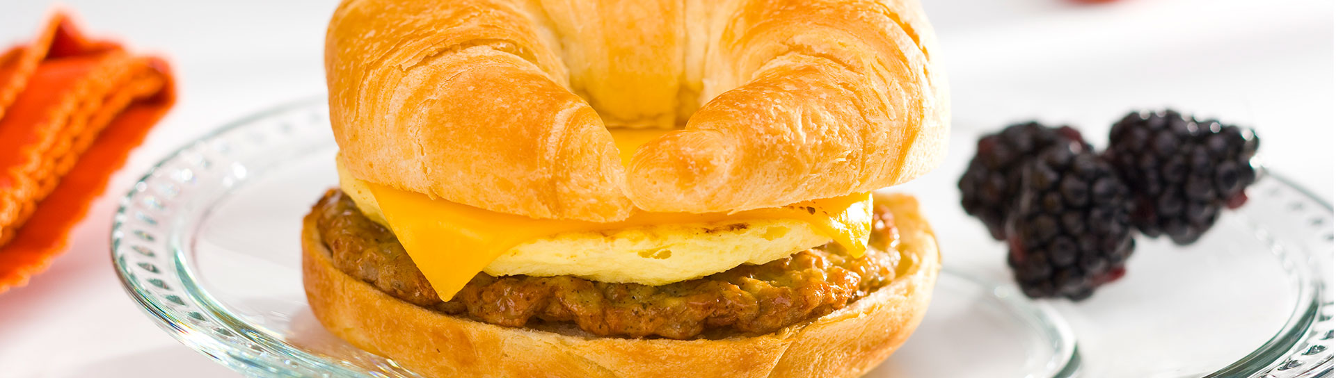 sausage and cheese croissant on a plate