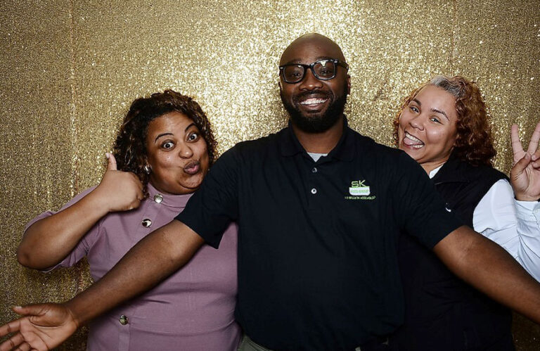 Associates have fun in a photobooth at the Groveport 10 year anniversary celebration
